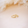 tiny huggies with gold ball texture on wood background