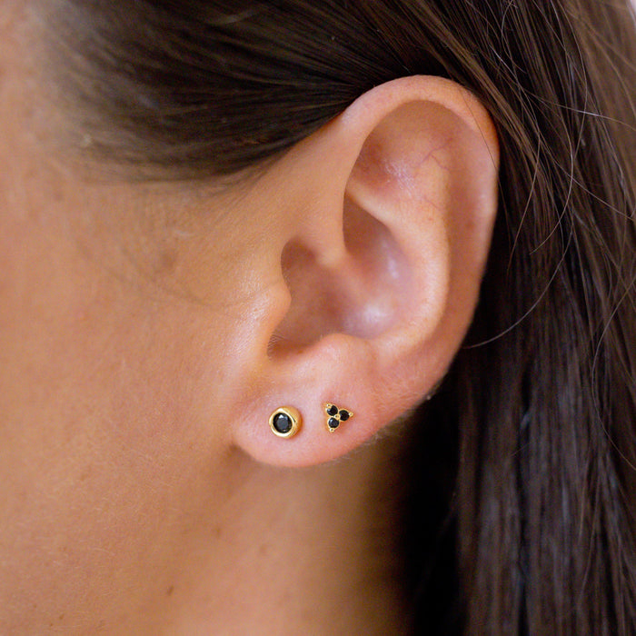 two onyx earring studs in ear