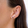 two onyx earring studs in ear