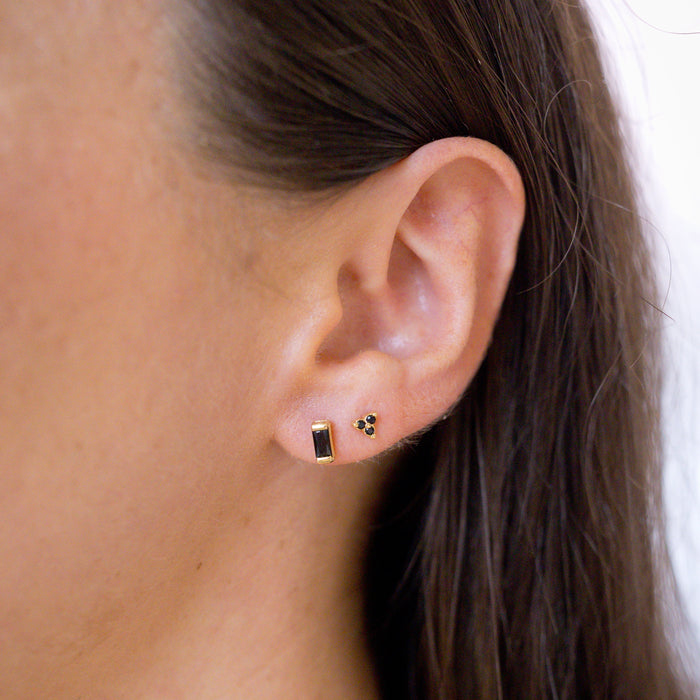 two onyx earring studs in ear