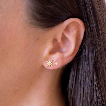 tiny sparkly starbust studs in ear