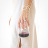 Hand holding a glass of red wine with a white background