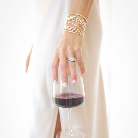 Hand holding a glass of red wine with a white background