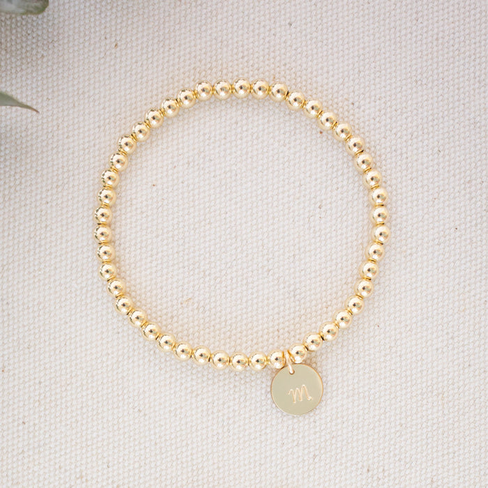 Two pearl bracelets on a light fabric background
