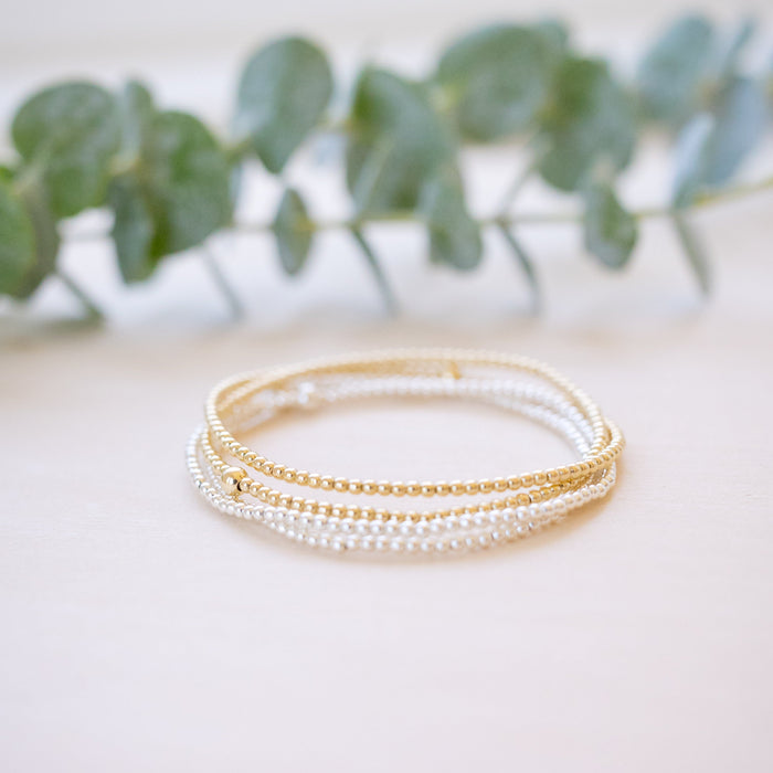 dainty gold beaded bracelet stack of four 
