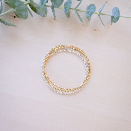dainty gold beaded bracelet stack of four 
