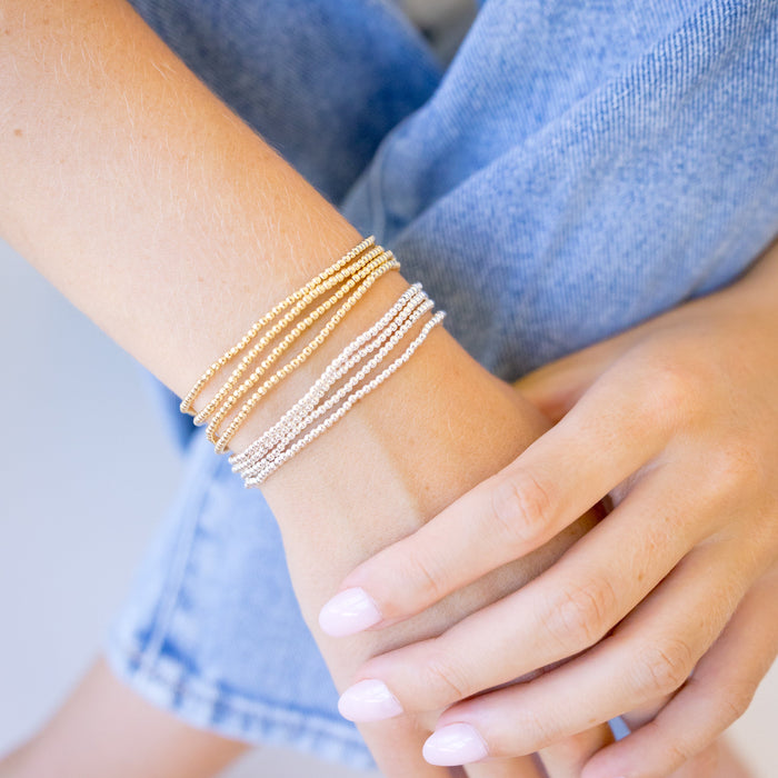 dainty gold beaded bracelet stack of four 