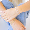 dainty gold beaded bracelet stack of four 