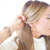 Woman adjusting her hair with a white background