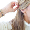 Person styling their hair with a white background