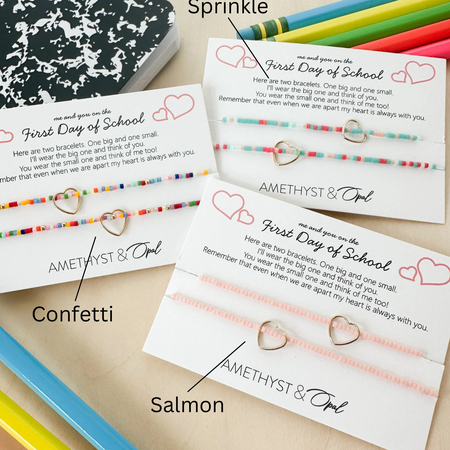 Three sets of bracelets with cards on a wooden surface, labeled 'Sprinkle', 'Confetti', and 'Salmon'.