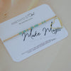 Gold bracelet with heart charm on a 'Make Magic' card by Amethyst & Opal