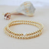 gold beaded bracelet stack - single freshwater pearl