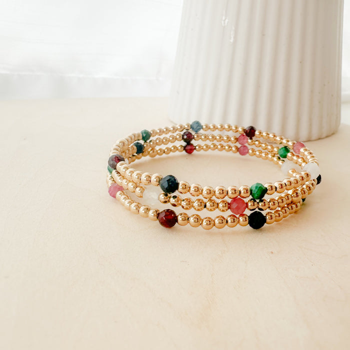 Gemma Bella Bracelet – gold-filled and natural gemstone bracelet with moonstone, malachite, sapphire, pink tourmaline, and garnet. Stackable, colorful, and festive.