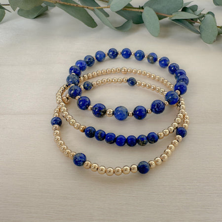 Stunning blue lapis beaded bracelet stack paired with shiny gold beads