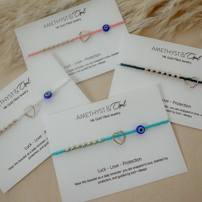 Amethyst & Owl jewelry bracelets on display with cards explaining their meanings.