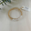 Gold beaded bracelet with 'AMETHYST & CO' tag on a light background
