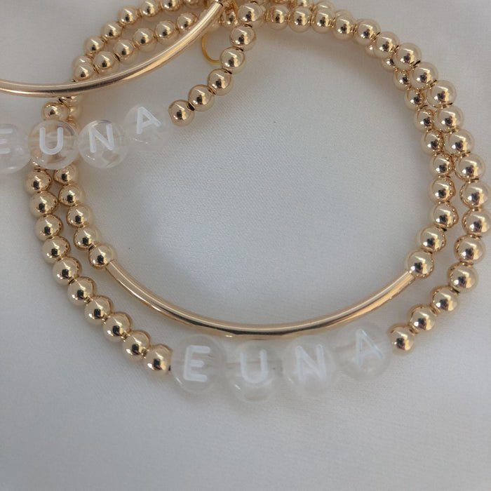 Personalized name + bar bracelet stack. Choose your letter bead color for a fully custom, stackable, everyday bracelet she’ll love.