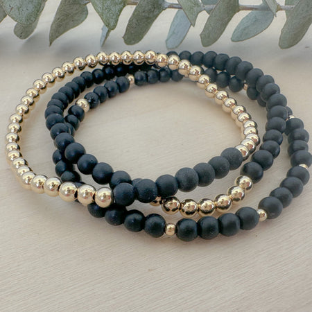Discover the Onyx Bracelet Stack—genuine onyx gemstone and gold beaded bracelet set. A meaningful, stylish jewelry gift for everyday wear.