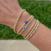 Evil Eye Bracelet – available in classic blue or white. Stackable gold-filled bracelet believed to protect against negative energy and bad luck.