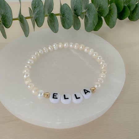 Personalized freshwater pearl bracelet with custom name, initials, or numbers. Timeless pearls + personal touch make it a meaningful gift.