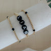 Personalized gold beaded bracelet with black letter beads. Customizable with initials or numbers, durable, chic, and perfect for everyday wear.